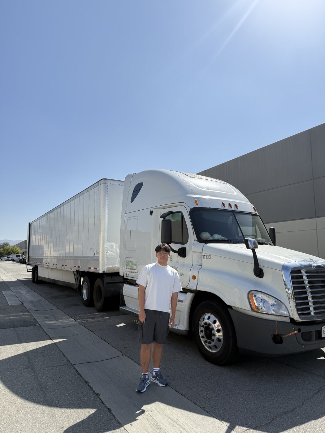 Ashton H. Jung in front of the trailer used to deliver books to Braille Institute