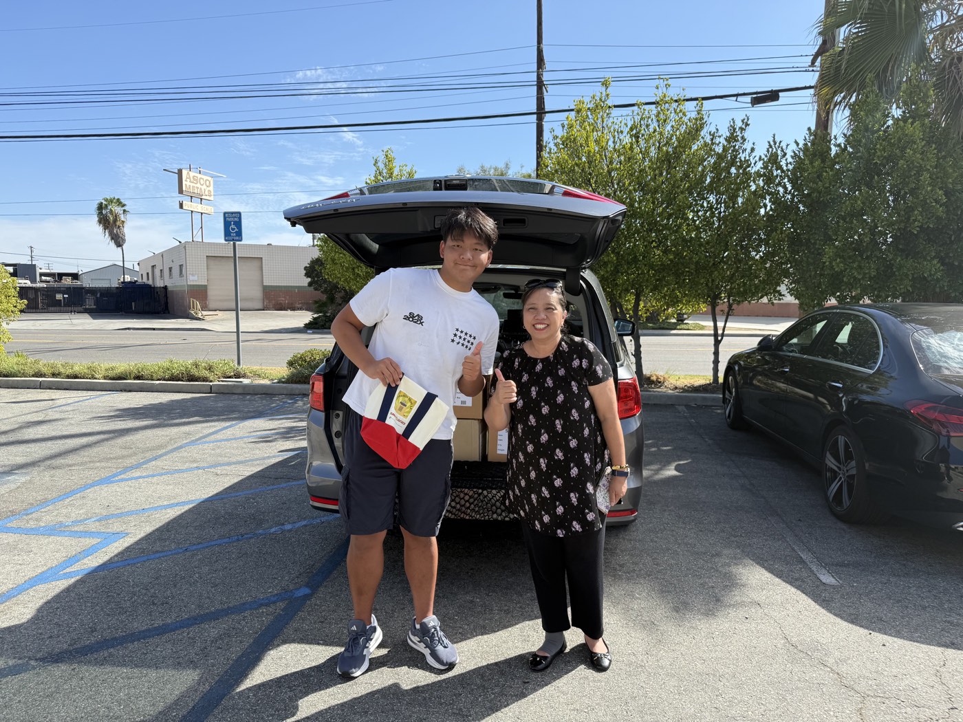 Ashton H. Jung and a Rotary Club of Historic Filipinotown representative delivering donated braille books